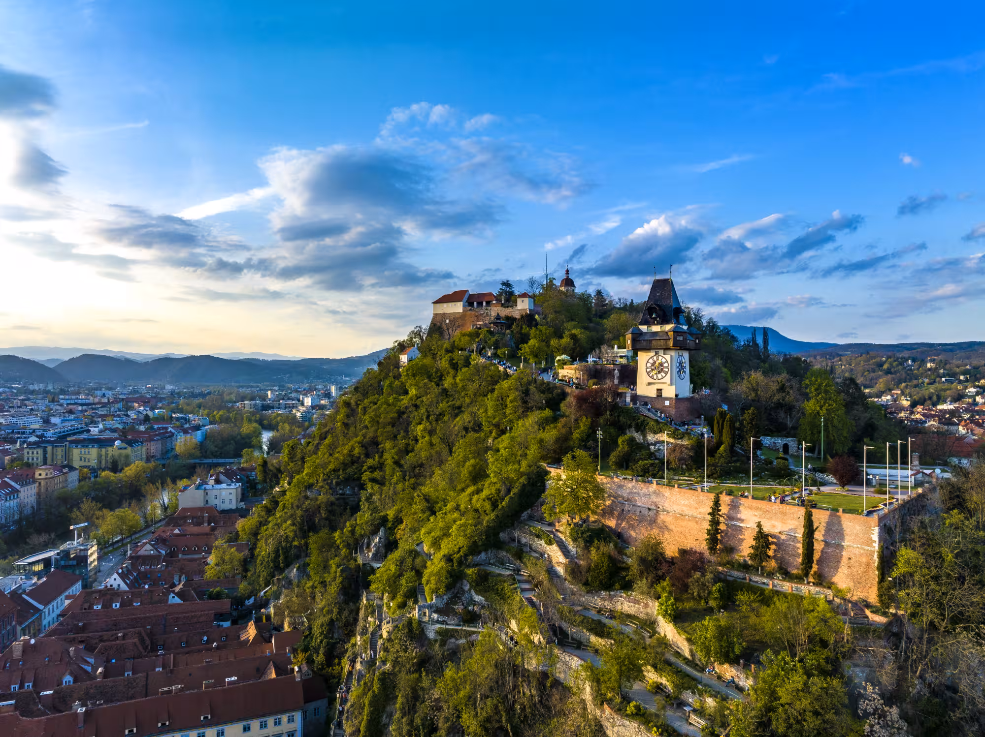 View over the city of Graz, the famous clocktower landmark in the center. (c) Graz Tourismus | Eibl View over the city of Graz,
the famous landmark clocktower 'Uhrturm' on the hill 'Schlossberg' in
the center. (c) Graz Tourismus | Eibl